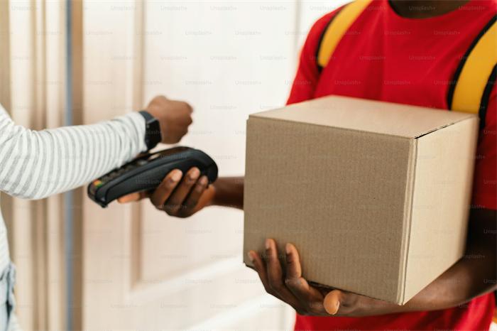 Warehouse worker checking parcel tracking and package receiving