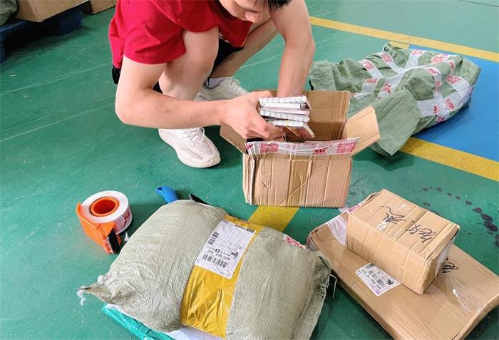 China warehouse worker checking parcels before consolidation and overseas delivery