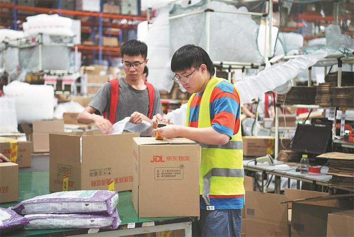 Warehouse workers packing goods for overseas delivery from China