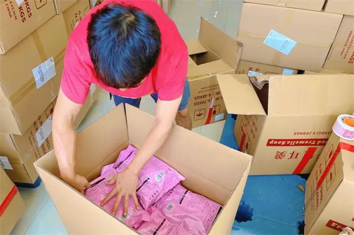 Warehouse worker consolidating multiple China parcels into one international shipment