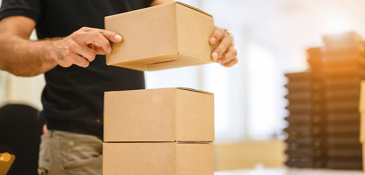 Package consolidation service: worker stacking multiple boxes into one shipment at a China freight forwarder warehouse