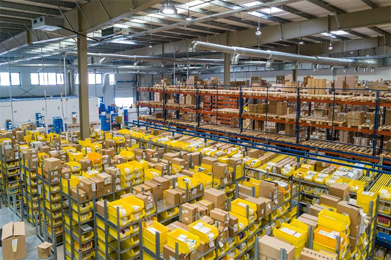 Stacked cardboard boxes a logistics warehouse, representing bulk shipping and freight consolidation savings