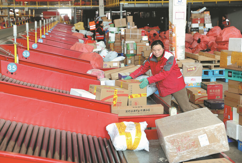 China warehouse worker receiving and sorting parcels from multiple suppliers