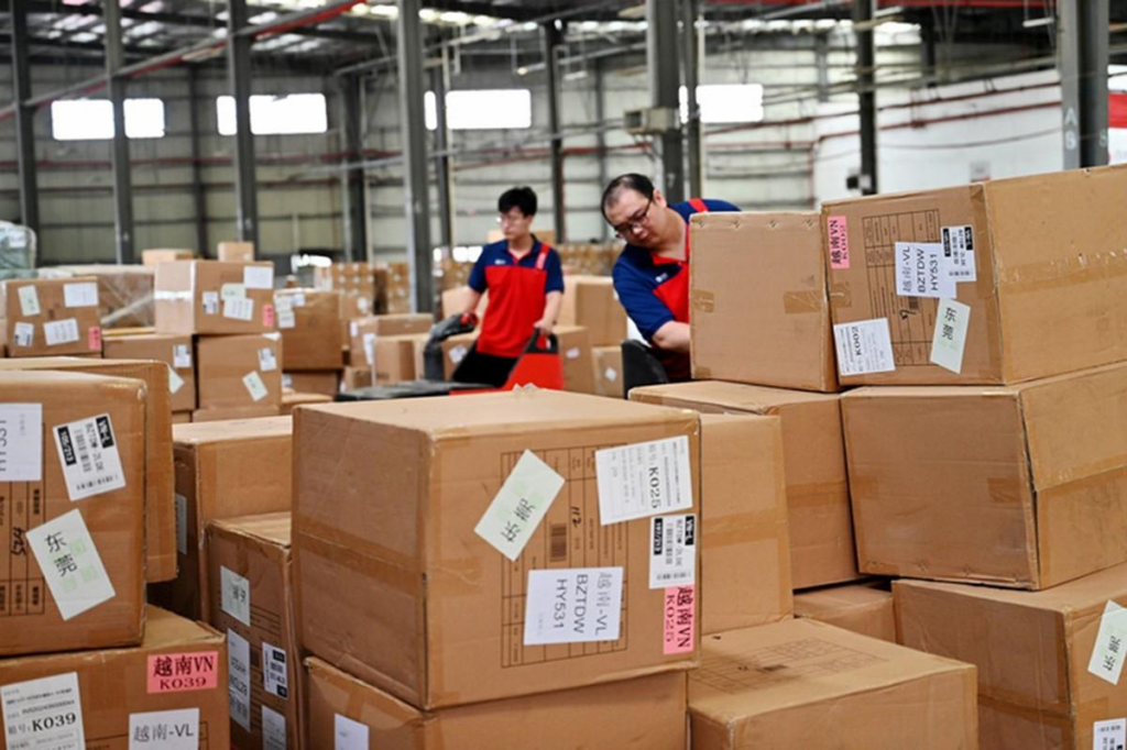 Warehouse workers receiving and sorting packages from Chinese suppliers